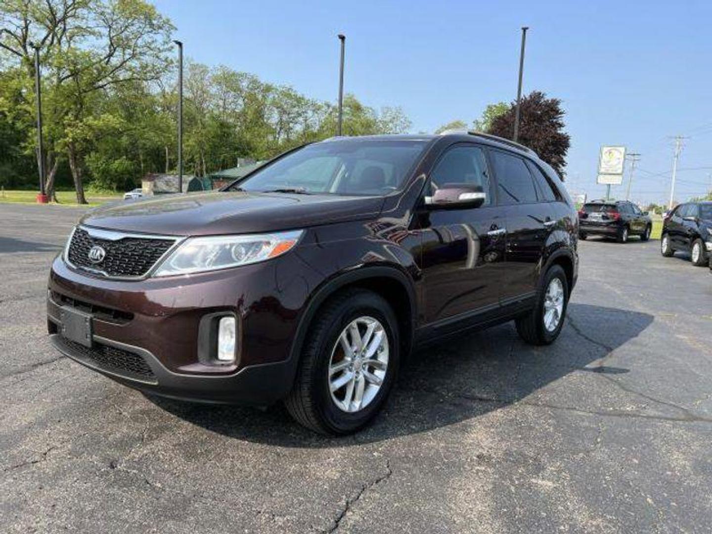 2015 Dark Cherry /Black Kia Sorento LX V6 FWD (5XYKT4A73FG) with an 3.3L V6 DOHC 24V engine, 6-Speed Automatic transmission, located at 6064 Gull Rd, Kalamazoo, MI, 49048, (269) 222-0088, 42.328388, -85.512924 - <b>Vehicle Details</b><br>Introducing the exceptional 2015 Kia Sorento LX, a remarkable SUV that combines versatility, reliability, and style. With only one previous owner and a clean CARFAX report, this vehicle is the epitome of dependability. Boasting a stunning exterior finished in a sleek and ti - Photo#1