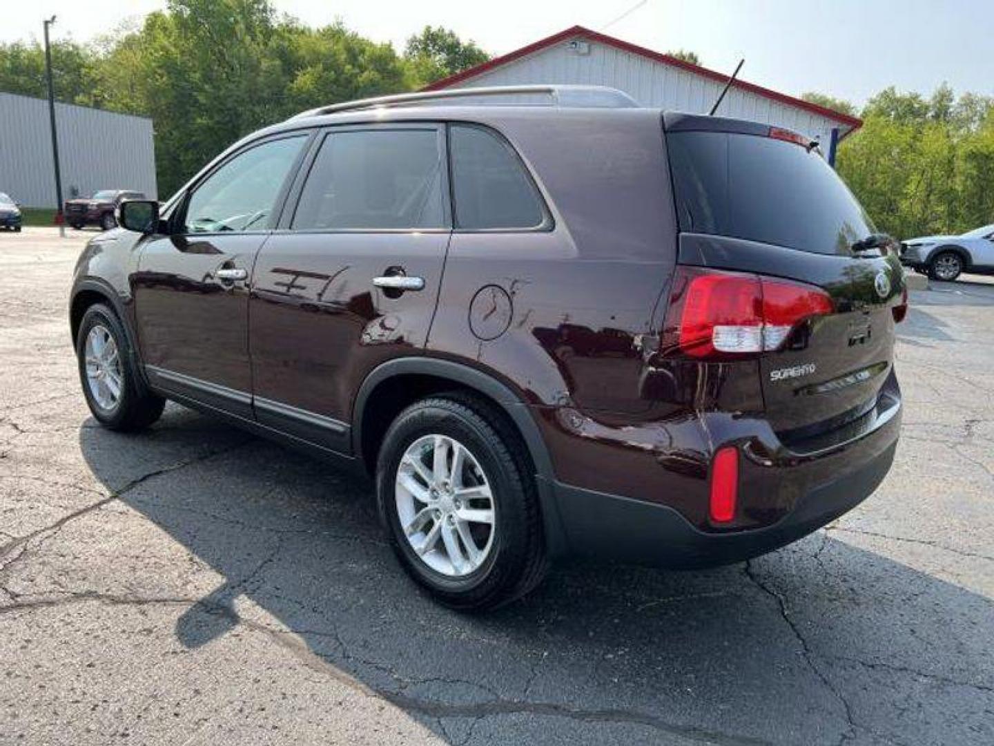 2015 Dark Cherry /Black Kia Sorento LX V6 FWD (5XYKT4A73FG) with an 3.3L V6 DOHC 24V engine, 6-Speed Automatic transmission, located at 6064 Gull Rd, Kalamazoo, MI, 49048, (269) 222-0088, 42.328388, -85.512924 - <b>Vehicle Details</b><br>Introducing the exceptional 2015 Kia Sorento LX, a remarkable SUV that combines versatility, reliability, and style. With only one previous owner and a clean CARFAX report, this vehicle is the epitome of dependability. Boasting a stunning exterior finished in a sleek and ti - Photo#3