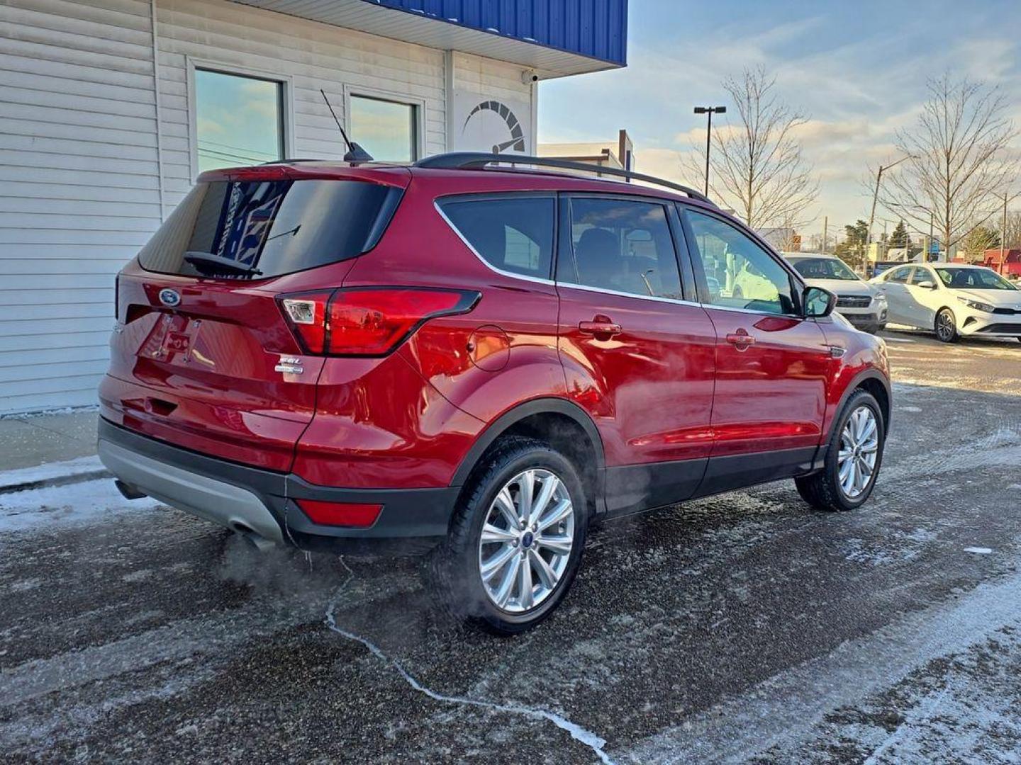 2019 Ruby Red Metallic Tinted Clearcoat /Charcoal Black Ford Escape SEL 4WD (1FMCU9HD2KU) with an 1.5L L4 DOHC 16V engine, 6A transmission, located at 234 Columbia Ave, Battle Creek, MI, 49015, (269) 222-0088, 42.298264, -85.192543 - When you encounter slick or muddy roads, you can engage the four wheel drive on the Ford Escape and drive with confidence. This small suv comes equipped with Android Auto for seamless smartphone integration on the road. Apple CarPlay: Seamless smartphone integration for this vehicle - stay connected - Photo#3